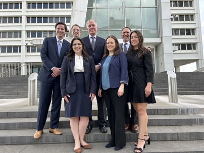 Drew and Milinda and their clients outside of court.