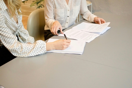 Two woman working on papers together