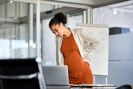 troubled pregnant employee at her desk