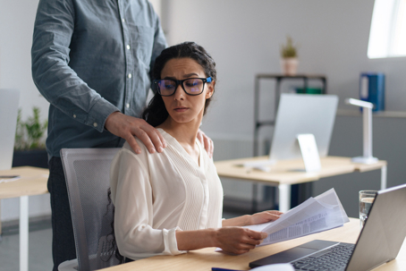 woman at work being touched inappropriately by male coworker